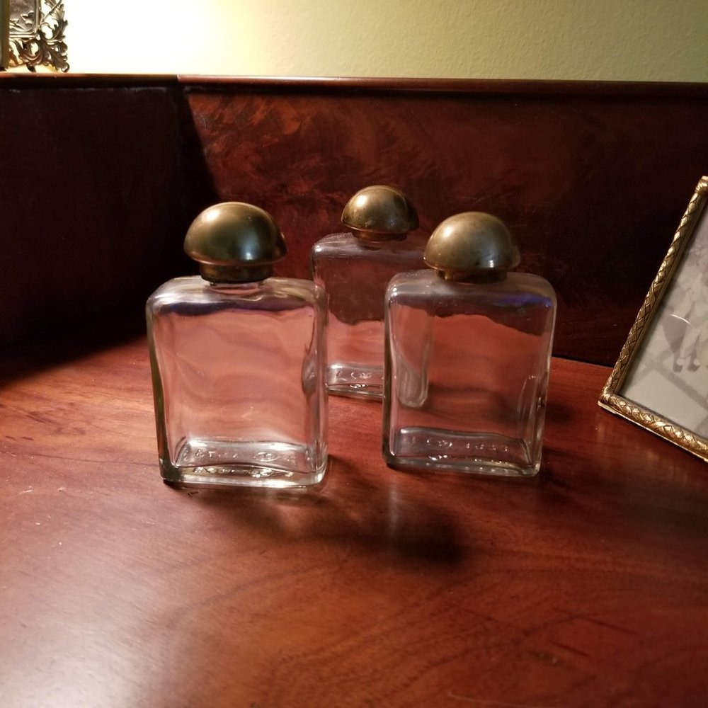 Vintage Glass Bottles with Brass tops from a suitcase.